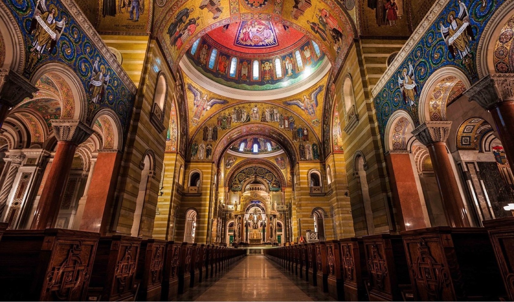 The illuminated nave and mosaic domes of the Cathedral Basilica of Saint Louis
